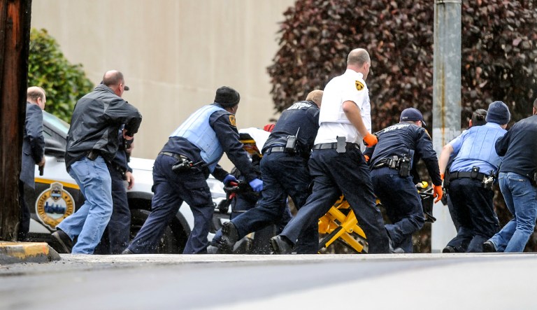 Law enforcement run with a person on a stretcher at the scene where multiple people were shot Saturday at the Tree of Life Congregation in Pittsburgh's Squirrel Hill neighborhood.