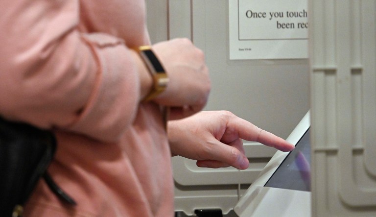 A woman casts her ballot.