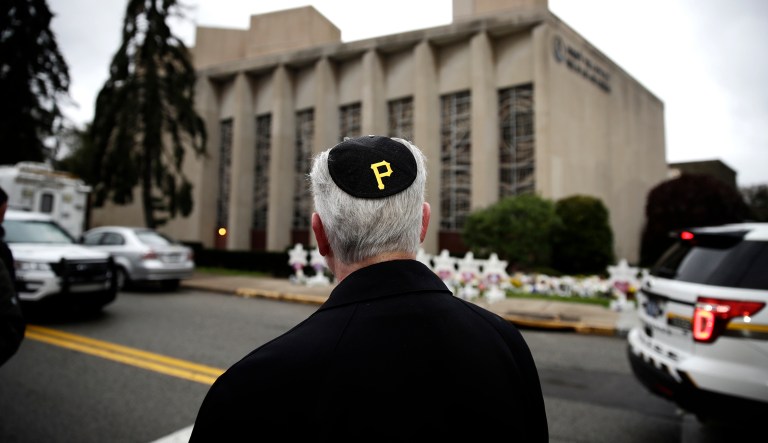 Rabbi Jeffrey Myers of the Tree of Life/Or L'Simcha Congregation stands near the synagogue and wears a yarmulke with a Pittsburgh Pirates logo, in Pittsburgh, Monday, Oct. 29, 2018. Robert Gregory Bowers, the suspect in the synagogue shooting that killed more than 10 people on Saturday is due for a court appearance on Monday.