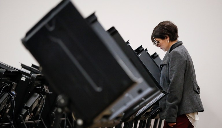 Voters use electronic polling machines as they cast their votes early at the Franklin County Board of Elections, Wednesday, Oct. 31, 2018, in Columbus, Ohio.