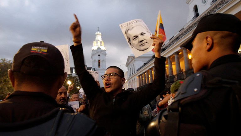 A man holds up an image of Julian Assange to show support for his double nationality.