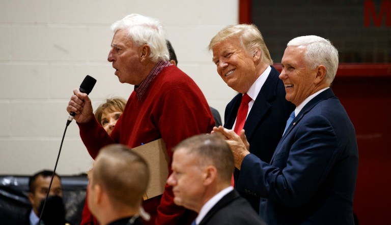 President Donald Trump and Vice President Mike Pence smile as former basketball coach Bob Knight speaks to an overflow crowd at a campaign rally at Southport High School, Friday, Nov. 2, 2018, in Indianapolis.