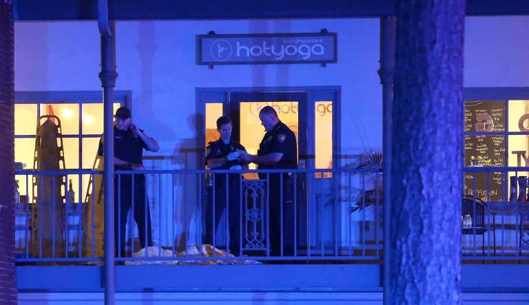 Police investigators work the scene of a shooting on Friday in Tallahassee, Fla. A shooter killed one person and critically wounded four others at a yoga studio in Florida's capital before killing himself Friday, officials said. 