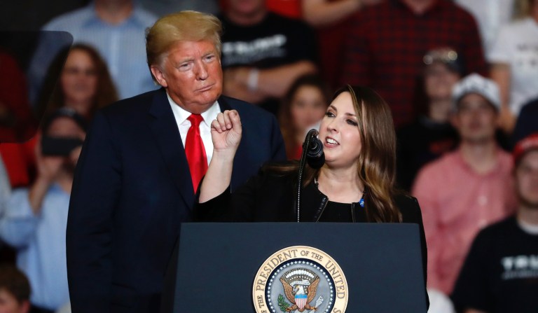 President Donald Trump listens as Chair of the Republican National Committee, Ronna McDaniel, right, speaks during a campaign rally Monday, Nov. 5, 2018, in Cape Girardeau, Mo. Together they have broken several fundraising records.