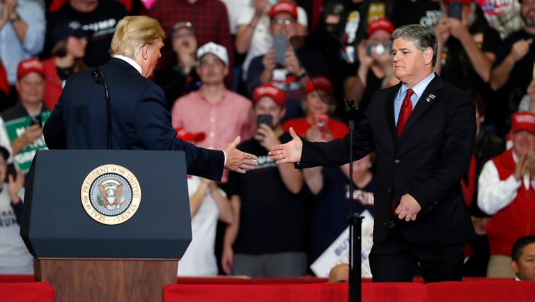 President Trump shakes hands with Fox News Channel's Sean Hannity.