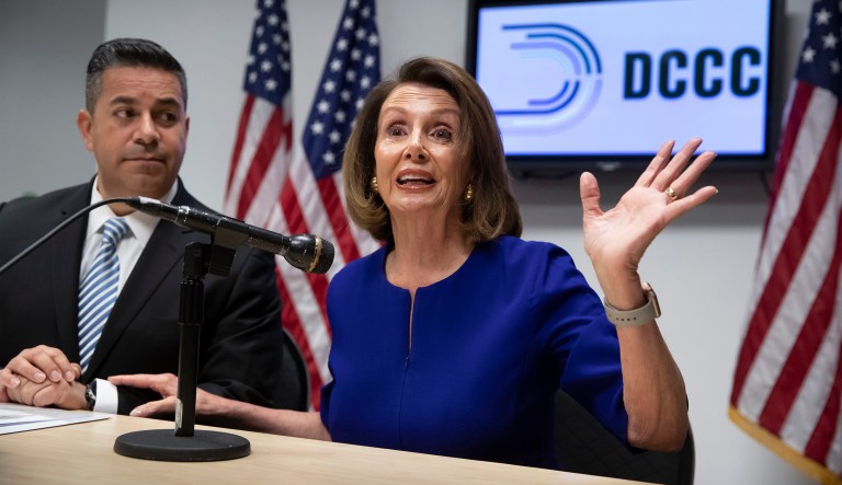 House Democratic Leader Nancy Pelosi of California, center, and Democratic Congressional Campaign Committee Chairman Rep. Ben Ray Lujan, D-N.M., left, speak with reporters on Election Day at the Democratic National Committee headquarters in Washington, Tuesday, Nov. 6, 2018.