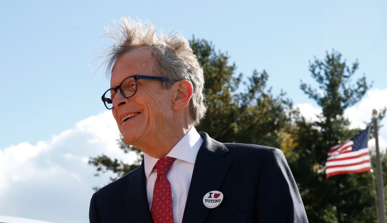 Ohio Republican gubernatorial candidate Mike DeWine greets a voter outside the Green Township Senior Center, a voting precinct, Tuesday, Nov. 6, 2018, in Cincinnati, Ohio.