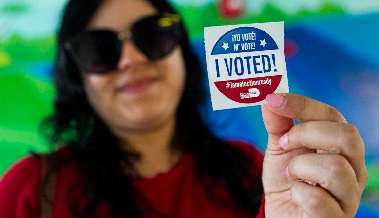 Carolina Cano, 31, a Sunset resident, holds a sticker after casting her vote at her precinct in Snapper Creek Elementary School on Tuesday, November 6, 2018.