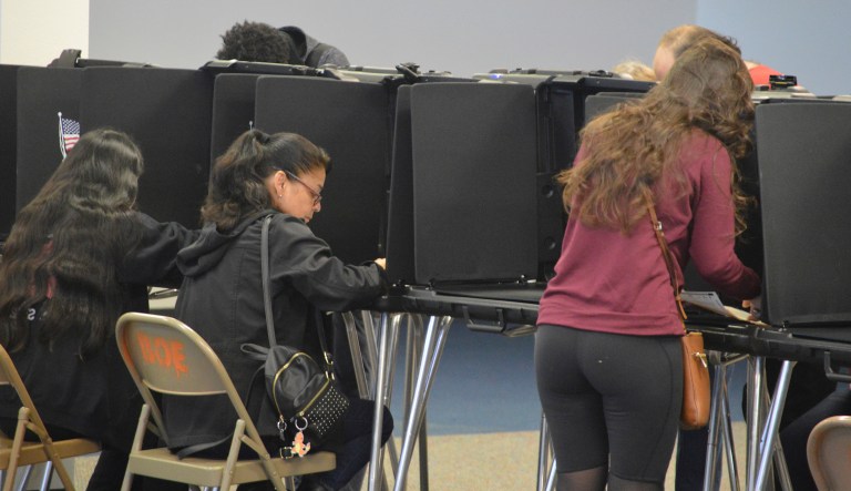 Residents at a southeastern Albuquerque, N.M., polling station search through their ballots on Tuesday, Nov. 6, 2018, on election day.   Voters in New Mexico went to the polls on Tuesday to pick the state's next governor, a U.S. senator, three U.S. House members and a string of statewide offices.