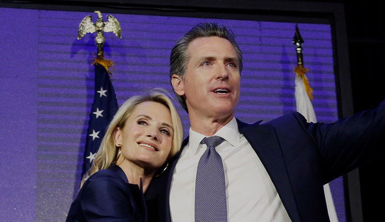 Gov. Gavin Newsom hugs his wife, Jennifer Siebel Newsom.
