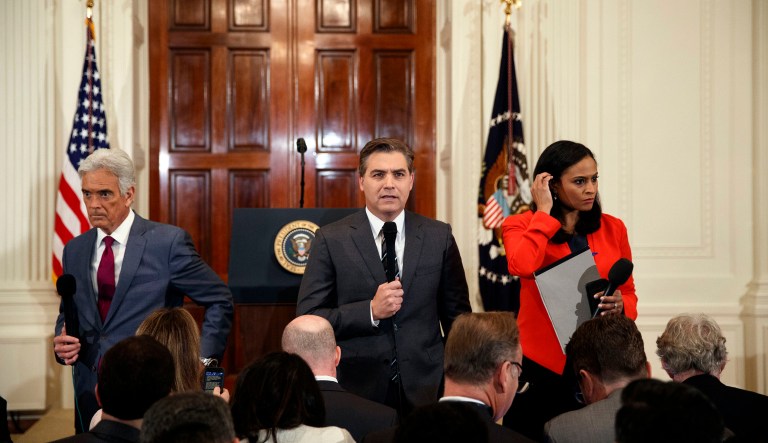 In this Nov. 7, 2018, photo, FOX news journalist John Roberts, left, CNN journalist Jim Acosta, center, and NBC journalist Kristen Welker, do stand ups before a news conference with President Donald Trump in the East Room of the White House in Washington.