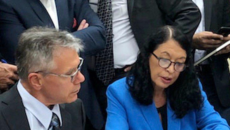 In this image taken from video, Susan Bucher, right, Palm Beach County Supervisor of Elections and Judge August Bonavita, left, look at provisional ballots in Riviera Beach, Fla..