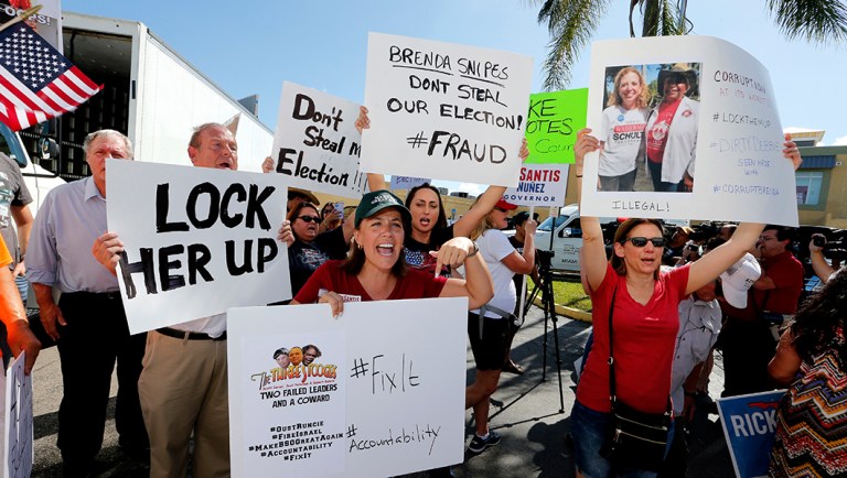 A crowd protests outside the Broward County Supervisor of Elections office.