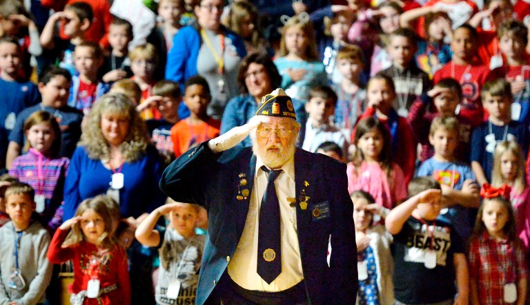 Dennis Bensur leads students, staff and faculty in a presentation of the colors during the 18th annual Veterans Day assembly at Elk Valley Elementary School in Lake City on Nov. 9. Bensur, 69, of Girard, is a Vietnam veteran who served in the U.S. Army.