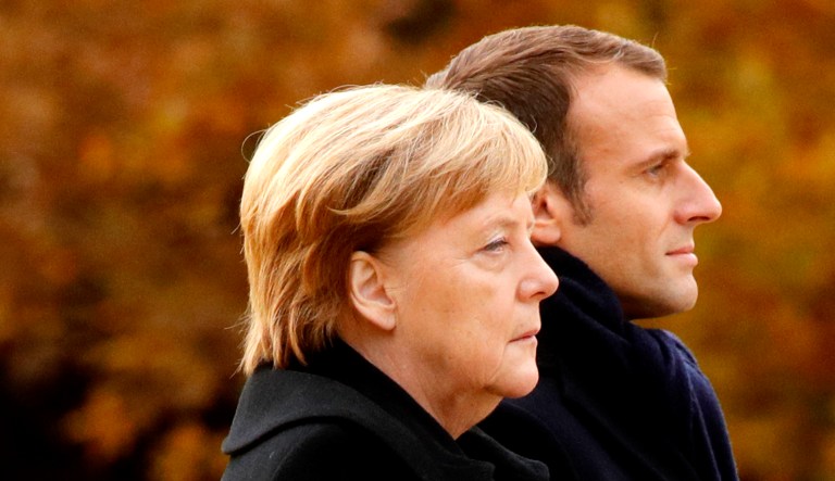 French President Emmanuel Macron and German Chancellor Angela Merkel attend an event.