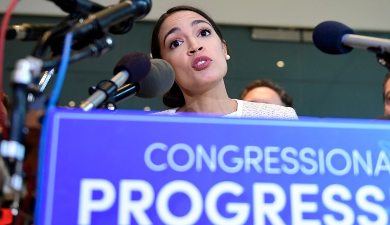 Rep. Alexandria Ocasio-Cortez, D-N.Y., talks during a news conference with members of the Progressive Caucus.