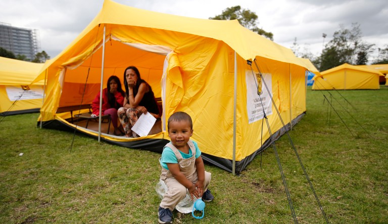 A young Venezuelan migrant plays amid a new, refugee-style camp set up by the government in Bogota, Colombia, Tuesday, Nov. 13, 2018. Officials were initially reluctant to open camps for homeless Venezuelan arrivals but now say they have no choice as the number fleeing their nationâs economic and humanitarian crisis continues to rapidly escalate.