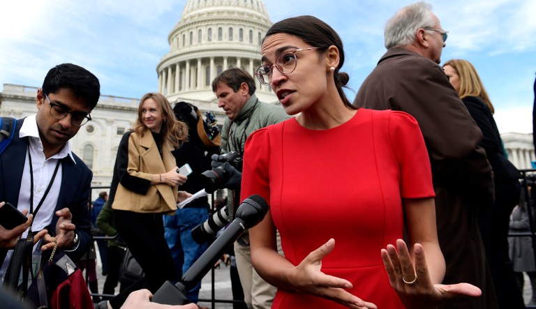 Rep.-elect Alexandria Ocasio-Cortez, D-N.Y., talks with reporters following a photo opportunity on Capitol Hill in D.C.