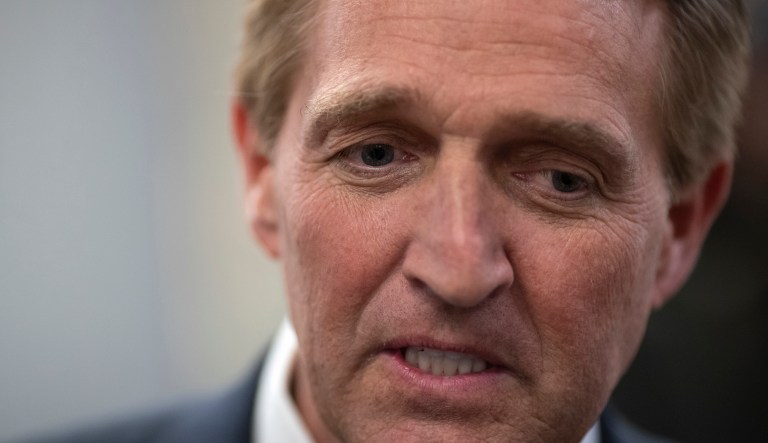 Sen. Jeff Flake, R-Ariz., speaks with reporters before he and Sen. Chris Coons, D-Del., try to bring up the legislation to protect special counsel Robert Mueller, at the Capitol in Washington, Wednesday, Nov. 14, 2018. 