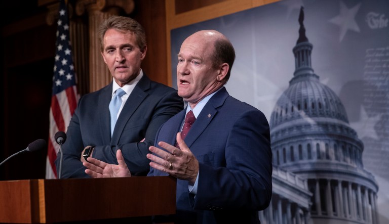 Sen. Jeff Flake, R-Ariz., left, and Sen. Chris Coons, D-Del., speak to reporters about their effort to bring up legislation to protect special counsel Robert Mueller, at the Capitol in Washington, Wednesday, Nov. 14, 2018.