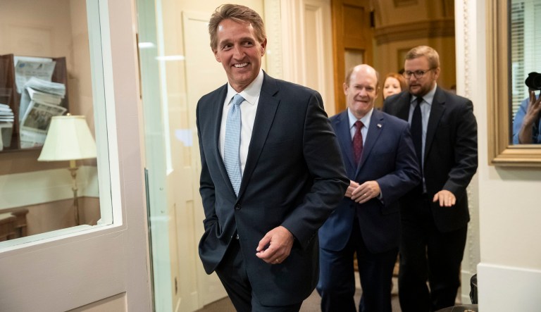 Sen. Jeff Flake, R-Ariz., left, and Sen. Chris Coons, D-Del., arrive to speak to reporters about their effort to bring up legislation to protect special counsel Robert Mueller, at the Capitol in Washington, Wednesday, Nov. 14, 2018. Senate Republicans are facing renewed pressure to pass legislation to protect Mueller, with a handful of GOP senators urging their leadership to hold a vote now that President Donald Trump has pushed out Attorney General Jeff Sessions. 