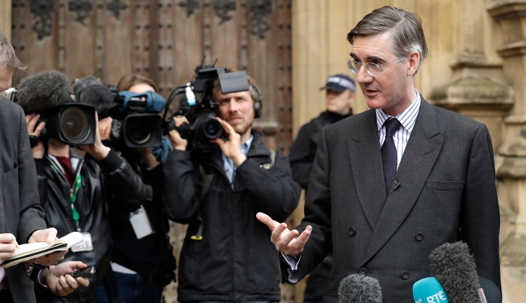 Pro-Brexit, Conservative lawmaker Jacob Rees-Mogg gestures as he speaks to the media outside the Houses of Parliament in London, Thursday, Nov. 15, 2018.