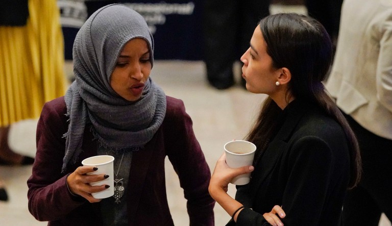 Rep.-elect Alexandria Ocasio-Cortez, D-NY., right, and Rep.-elect IIhan Omar, D-Minn., left, talk over coffee before heading to member-elect briefings on Capitol Hill in Washington, Thursday, Nov. 15, 2018.