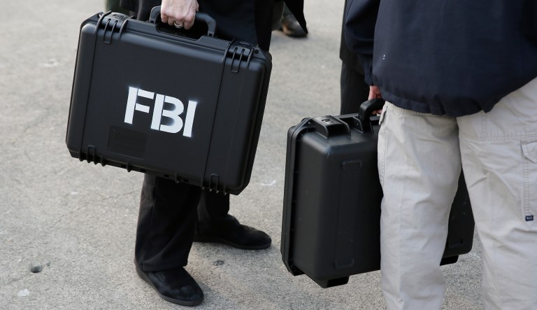 FBI agents carry waterproof cases containing newly 3d printed decoy heads, used to mount a famous prison escape in 1962, to a news conference on Alcatraz Island Thursday, Nov. 15, 2018, in San Francisco. 