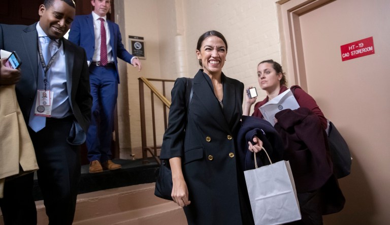 Rep.-elect Alexandria Ocasio-Cortez, D-N.Y., joined at left by Rep.-elect Joe Neguse, D-Colo., exit a Democratic Caucus meeting in the basement of the Capitol as new members of the House and veteran representatives gathered behind closed doors to discuss their agenda when they become the majority in the 116th Congress, in Washington, Thursday, Nov. 15, 2018. 