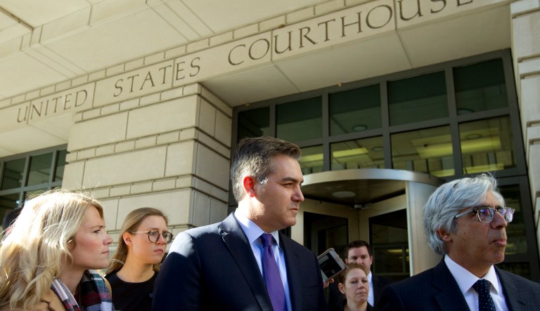 CNN's Jim Acosta listens as lawyer Ted Boutrous speaks to the media as they leave the U.S. District Courthouse, Friday, Nov. 16, 2018, in Washington.