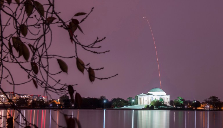 In this long exposure photo released by NASA, the Northrop Grumman Antares rocket, with Cygnus resupply spacecraft onboard, is seen above the Thomas Jefferson Memorial as it launches from Pad-OA on Saturday at NASA's Wallops Flight Facility in Va. 