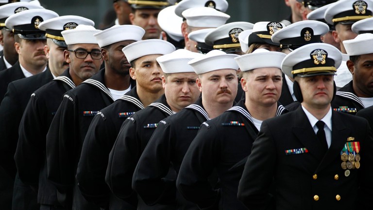 Crew members of the USS Sioux City stand in formation.