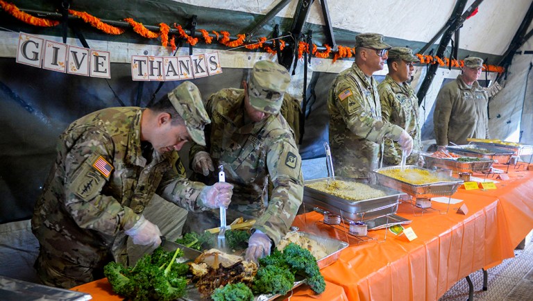 U.S. Army soldiers serve Thanksgiving dinner to soldiers deployed as part of Operation Faithful Patriot at the border in Donna, Texas.