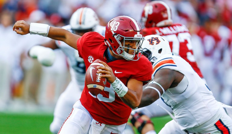 Alabama quarterback Tua Tagovailoa (13) escapes pressure from Auburn defensive lineman Marlon Davidson (3) during the first half of an NCAA college football game on Saturday in Tuscaloosa, Ala. 