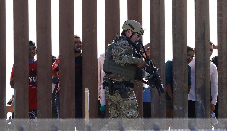U.S. Customs and Border Protection officers walks along a wall at the border between Mexico and the United States, as seen from San Diego on Sunday, Nov. 25, 2018. Migrants approaching the U.S. border from Mexico were enveloped with tear gas Sunday after a few tried to breach a fence separating the two countries. The Border Patrol office in San Diego said via Twitter that pedestrian crossings have been suspended at the San Ysidro port of entry at both the East and West facilities. All northbound and southbound traffic was halted.