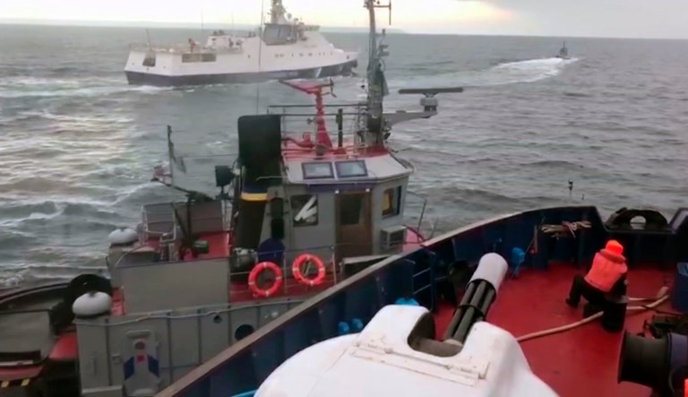 This image, taken from video released by Russia's Federal Security Service, is taken from a Russian Coast Guard vessel purporting to show an incident between the Russian coast guard and a Ukrainian tugboat, in the Kerch Strait on Sunday Nov. 25, 2018. Russia said three Ukrainian vessels made an unauthorised passage through Russian territorial waters, while Ukraine alleged that one of its boats was rammed by a Russian coast guard vessel.