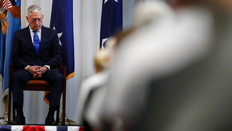 Secretary of Defense Jim Mattis sits on stage during a change of command ceremony.