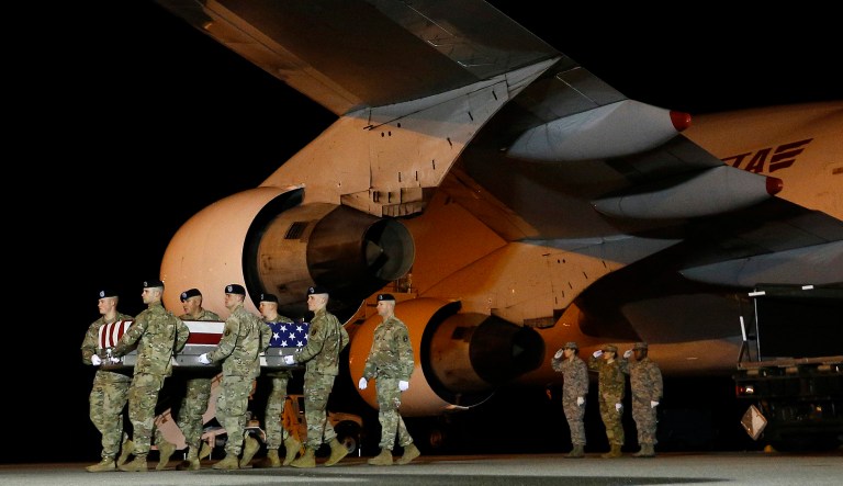 In this Nov. 26, 2018, photo, a U.S. Army team moves a transfer case containing the remains of Sgt. Leandro A. Jasso, at Dover Air Force Base, Del.