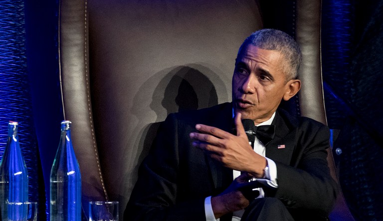 Former President Barack Obama speaks with Jon Meacham as he takes the stage during the 25th anniversary gala celebration for Rice University's Baker Institute for Public Policy on Tuesday, Nov. 27, 2018, in Houston.