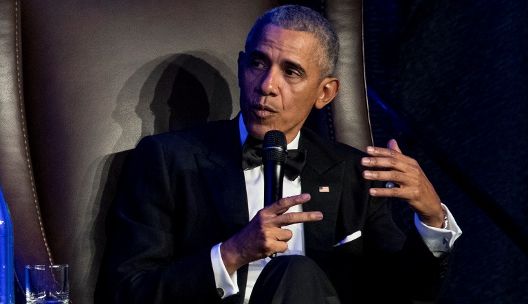 Former President Barack Obama speaks with Jon Meacham as he takes the stage during the 25th anniversary gala celebration for Rice University's Baker Institute for Public Policy on Tuesday, Nov. 27, 2018, in Houston.