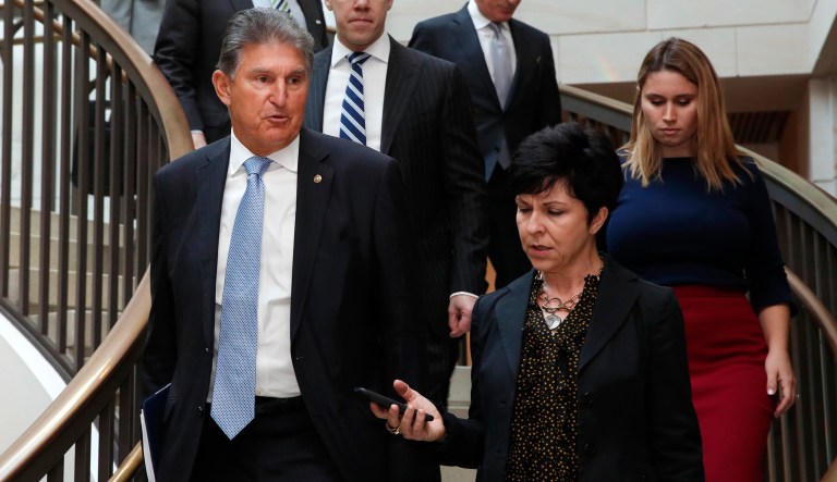 Sen. Joe Manchin, D-W.Va., left is interviewed by a reporter as he arrives for a closed door meeting about Saudi Arabia, Wednesday, Nov. 28, 2018, on Capitol Hill in Washington.