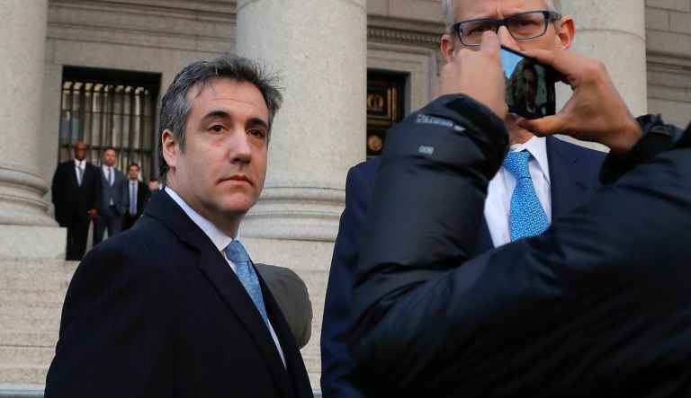 Michael Cohen, left, walks out of federal court with his attorney Guy Petrillo,Thursday, Nov. 29, 2018, in New York, after pleading guilty to lying to Congress about work he did on an aborted project to build a Trump Tower in Russia., Cohen told the judge he lied about the timing of the negotiations and other details to be consistent with Trump's "political message."