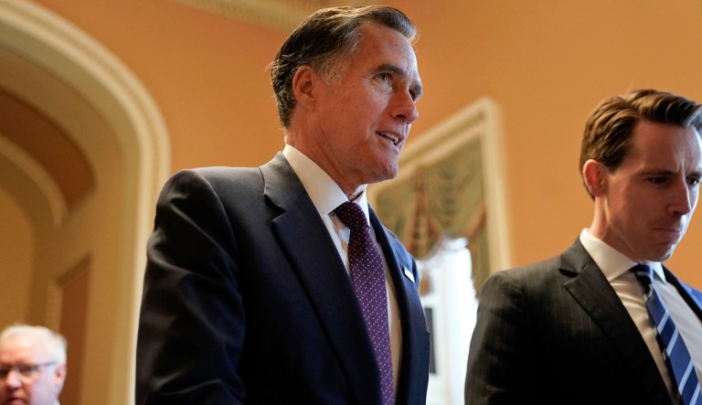 FILE - In this Nov. 14, 2018, file photo, Sen.-elect Mitt Romney, R-Utah, center, walks the hallway on Capitol Hill in Washington. Romney is a man in-between. He made it to Washington after all _ but not as president of the United States, the office he sought twice and other men won. Heâs not yet a senator from Utah, either, until heâs sworn in Jan. 3.  