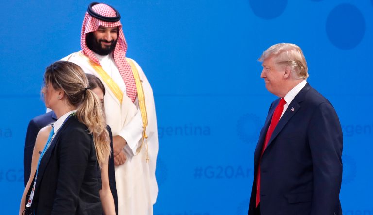 President Donald Trump, right, smiles as he walks past Saudi Arabia's Crown Prince Mohammed bin Salman, left, as he arrives and joins other heads of state for a family photo at the G20 summit, Friday, Nov. 30, 2018 in Buenos Aires, Argentina. 