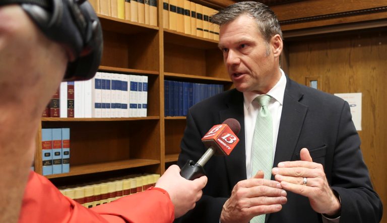 Former Republican Kansas Secretary of State Kris Kobach answers questions from reporters after he and other state officials certify results from the state's recent general election, Friday, Nov. 30, 2018, in Topeka, Kan. 