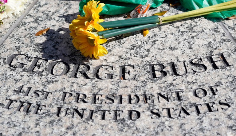 Flowers are placed at the foot of a statue of George H.W. Bush outside the George H.W. Bush Presidential Library and Museum Saturday, Dec. 1, 2018, in College Station. Bush has died at age 94. Family spokesman Jim McGrath says Bush died shortly after 10 p.m. Friday, Nov. 30, 2018, about eight months after the death of his wife, Barbara Bush.