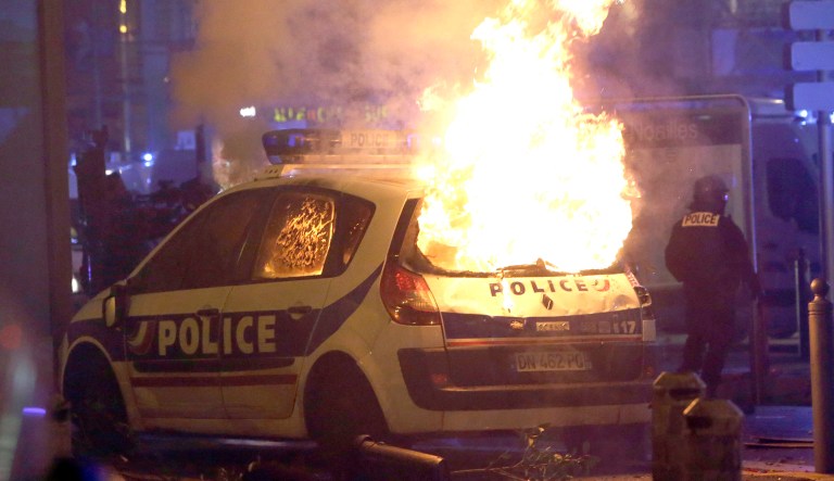 A police car burns after clashes between police and protesters, in Marseille, southern France, Saturday, Dec. 1, 2018, demonstrating against what they claim were dilapidated residential buildings that collapsed Monday Nov. 5, killing eight people.  French authorities on Saturday deployed some thousands of police on Paris' Champs-Elysees avenue to try to contain protests by people angry over rising taxes and President Emmanuel Macron's government.