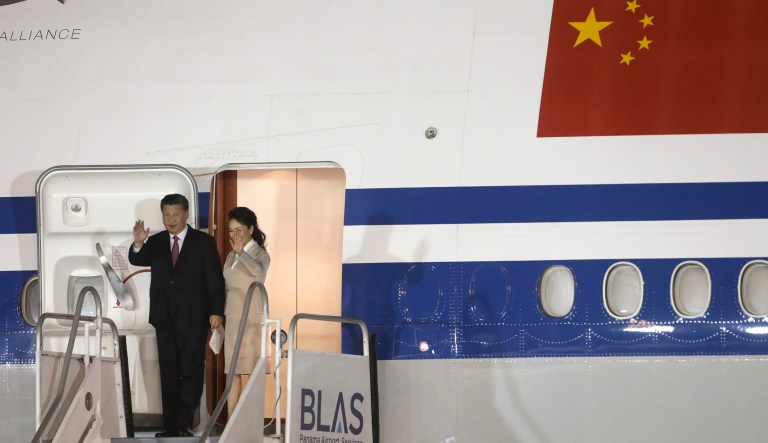 China's President Xi Jinping, left, and first lady Peng Liyuan wave from their plane as they arrive to Tocumen International Airport in Panama City, Sunday, Dec. 2, 2018. Xi Jinping is in Panama for his first trip since Panama cut ties with Taiwan in favor of resuming or establishing relations with China. 