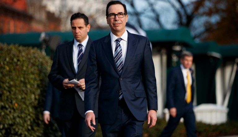 Treasury Secretary Steven Mnuchin walks over to talk with reporters about trade negotiations with China, at the White House, Monday, Dec. 3, 2018, in Washington.