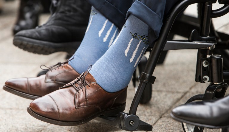 Former President George H.W. Bush wears socks depicting military jets flying in formation during a Pearl Harbor remembrance ceremony at the George Bush Presidential Library in College Station, Texas on Dec. 7, 2016.